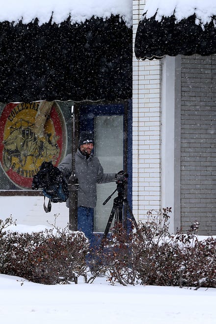 TV crews were out early, Monday, Feb. 15, collecting footage of the overnight snow blanketing downtown Fort Smith.
