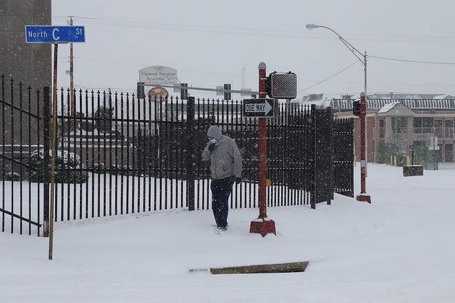 A man walks along Grand Ave at N C St, Monday, Feb. 15, in Fort Smith.