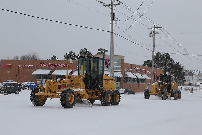 A pair of Fort Smith Street Department road graders clear both lanes on Massard that cross Rogers Ave. Monday, Feb. 15, in Fort Smith.
