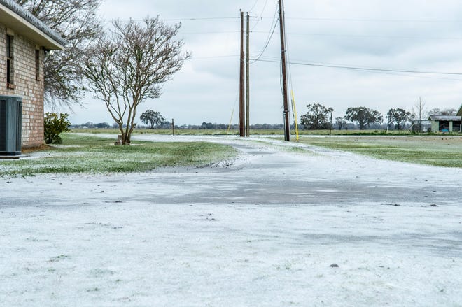 Ice blankets a driveway in Maurice, Louisiana Monday, Feb. 15, 2021.