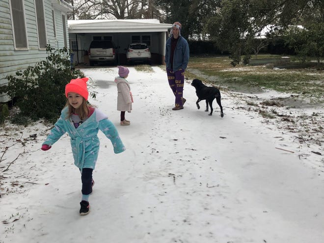 The Guidry family enjoys the rare Louisiana snow on their driveway in Crowley on Monday, Feb. 15, 2021.
