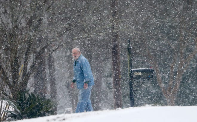 Snowfall greeted West Alabama residents Tuesday, Feb. 16, 2021. Snow falls all around Jimmy Greene as he checks his mail on Dove Creek Avenue. [Staff Photo/Gary Cosby Jr.]