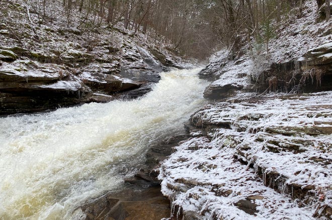 Waters flowing into Yellow Creek from the Lake Nicol overflow pass through a wintery scene Tuesday, Feb. 16, 2021. [Staff Photo/Gary Cosby Jr.]