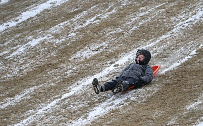 Luke Farmer sleds down a hillside in NorthRiver Yacht Club Tuesday, Feb. 16, 2021. Much of the snow had already been worn down by many people sledding the hillside. Luke said he had been down six or seven times. [Staff Photo/Gary Cosby Jr.]