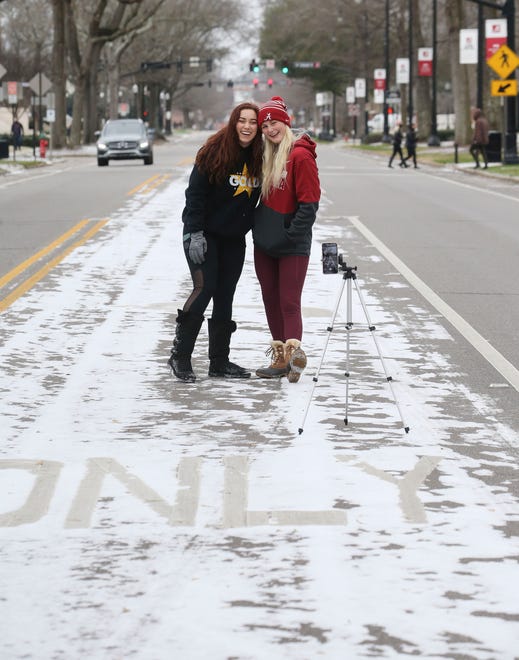 University of Alabama students Natalie Crisci and Savannah Slater grad a quick selfie with a dusting of snow on University Blvd. Tuesday, Feb. 16, 2021. [Staff Photo/Gary Cosby Jr.]