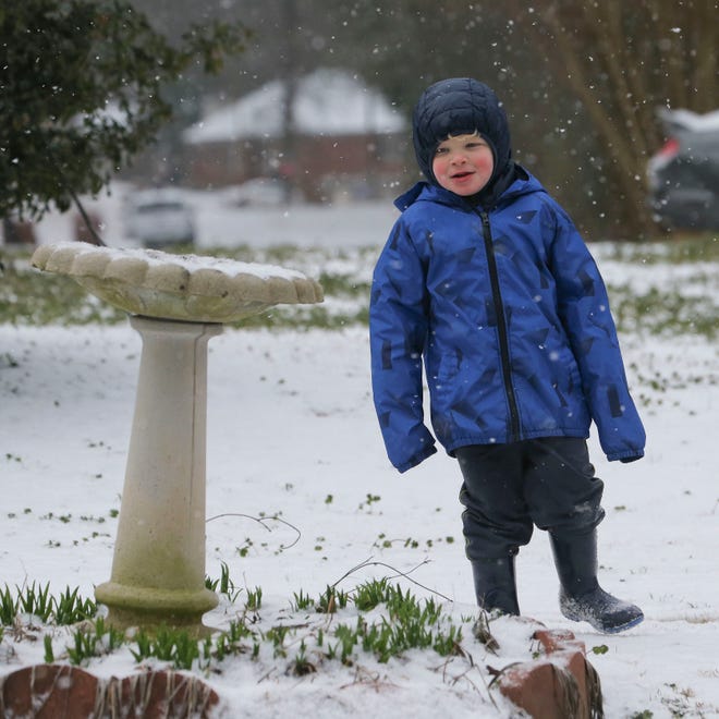 Snowfall greeted West Alabama residents Tuesday, Feb. 16, 2021. Grayson Hardin enjoys a rare snow day as he plays outside early Tuesday. [Staff Photo/Gary Cosby Jr.]