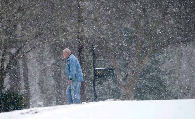 Snowfall greeted West Alabama residents Tuesday, Feb. 16, 2021. Snow falls all around Jimmy Greene as he checks his mail on Dove Creek Avenue. [Staff Photo/Gary Cosby Jr.]