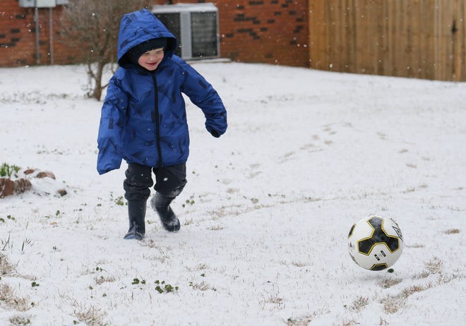 Snowfall greeted West Alabama residents Tuesday, Feb. 16, 2021. Grayson Hardin plays with his soccer ball and enjoys the rare snow day. [Staff Photo/Gary Cosby Jr.]