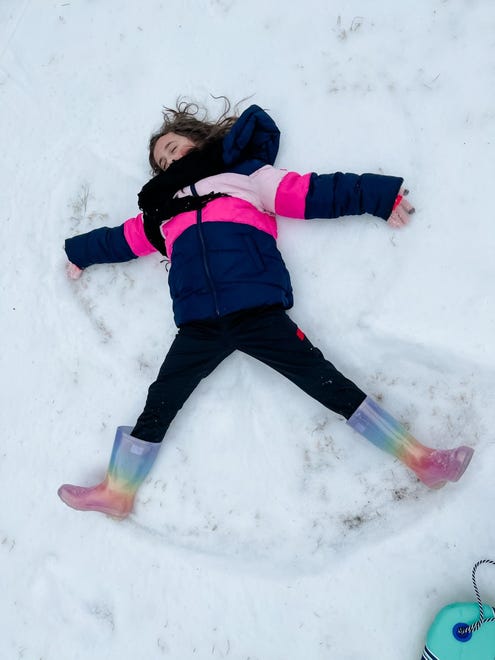 Alynn Raburn makes a snow angel in Franklin, Tenn. on Tuesday, Feb. 16, 2021.