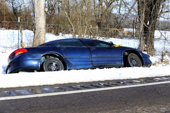 An car rest on its side in a ditch on Hwy 45 S, Thursday, Feb. 18, in Fort Smith.